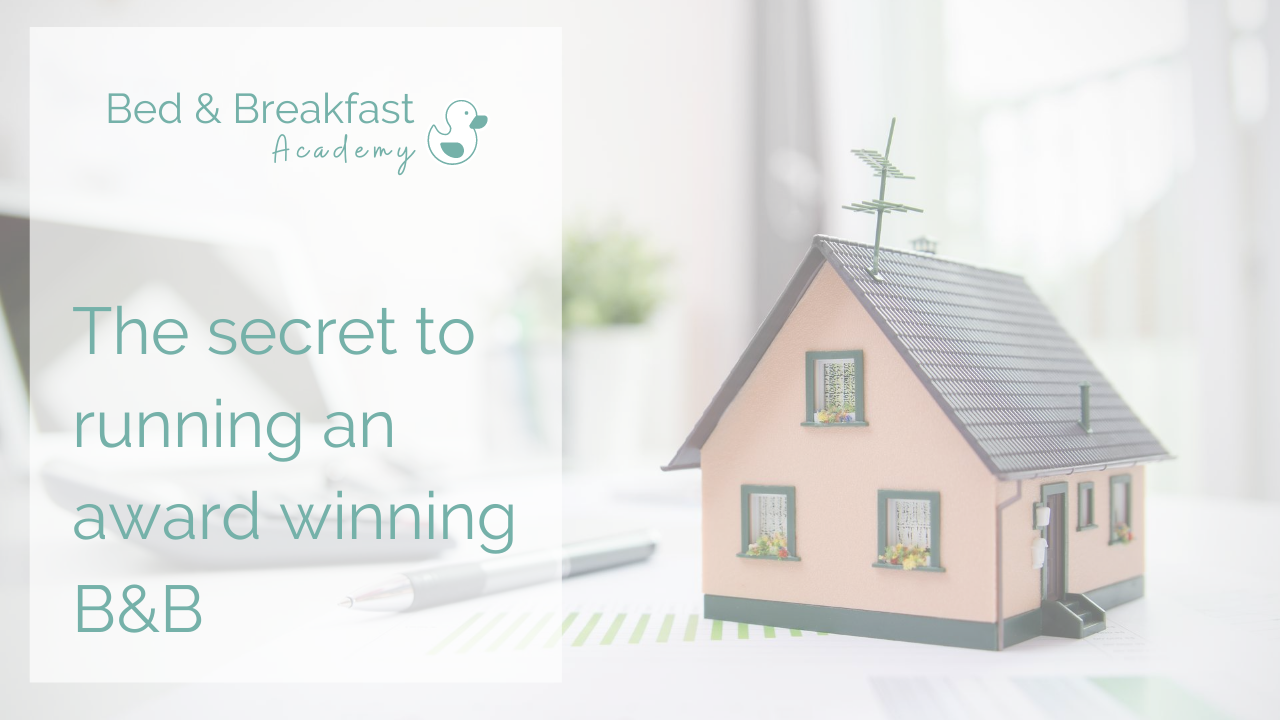 The secret to running an award winning B&B | pink miniature house sitting on a desk