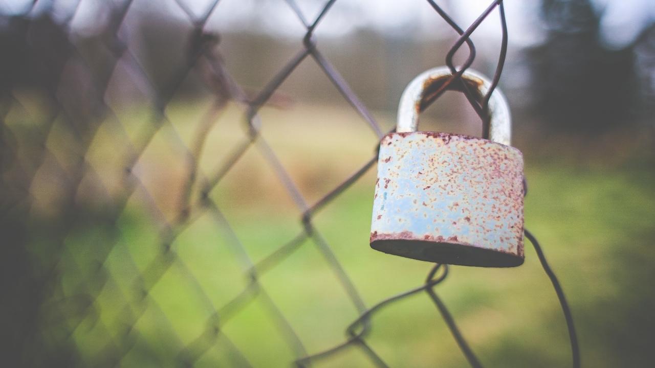 padlock on a chain link fence