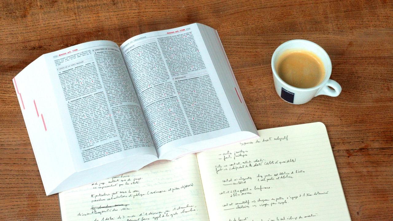 book and coffee sitting on a table