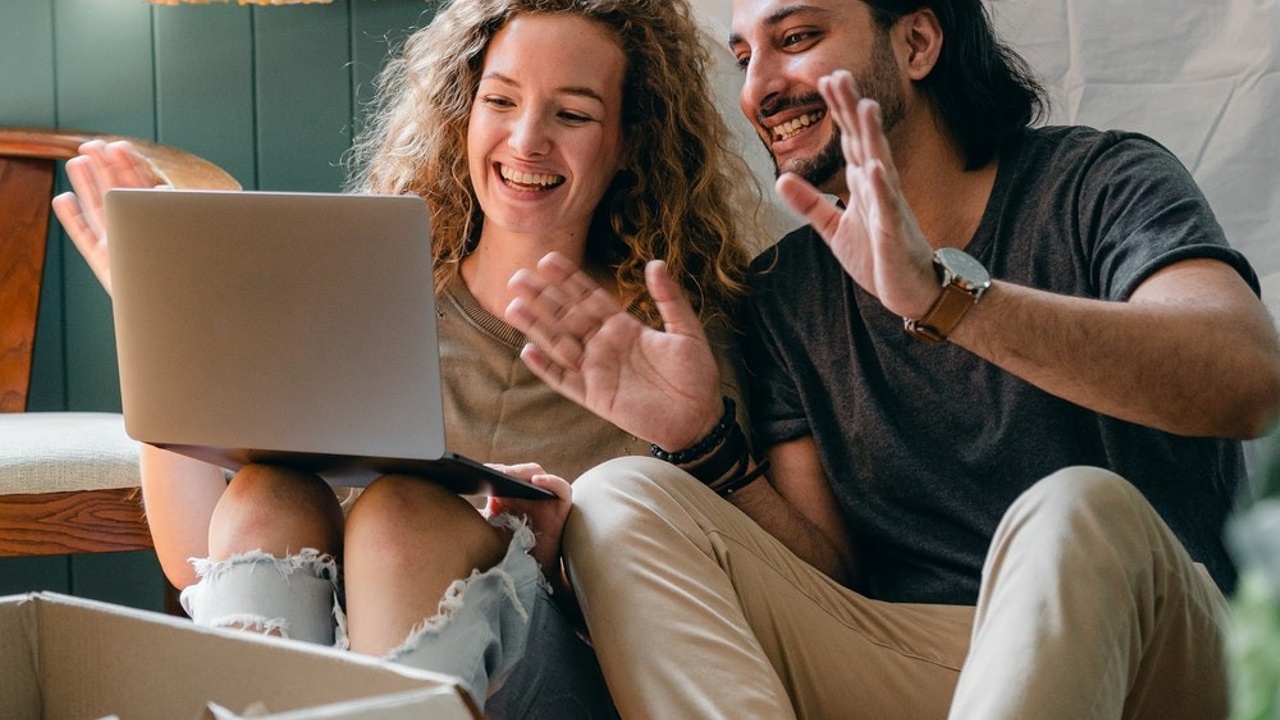 happy couple on a computer