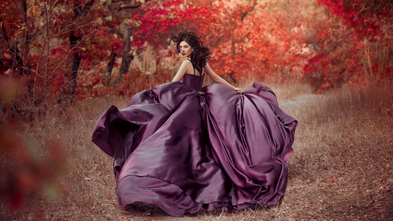 Woman in a purple dress running into the forest seeking her fairytale ending