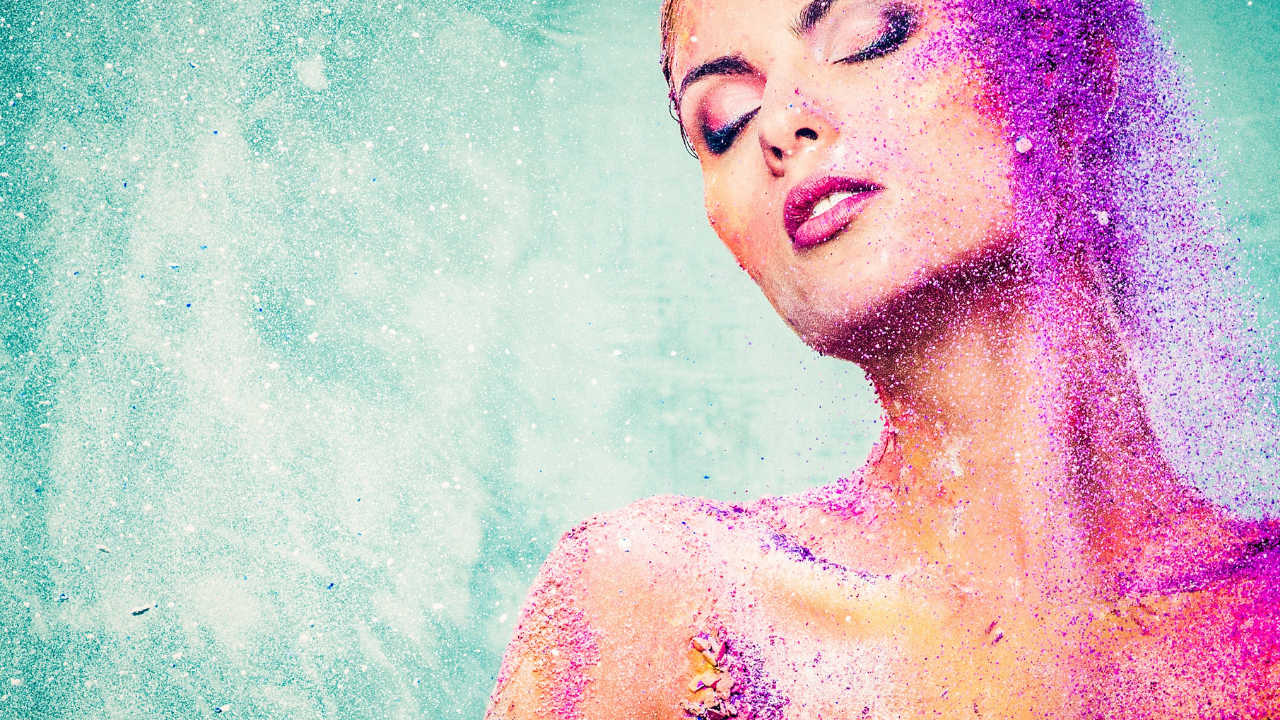 Woman with cosmic purple body art colour with turquoise background for cosmic effect to show freedom by listening to our soul