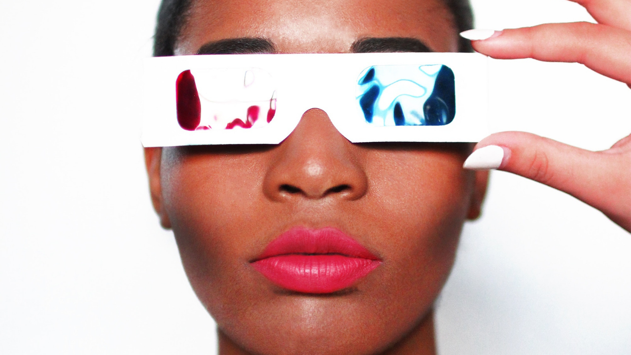 Woman holding 3D glasses to her face as a visionary