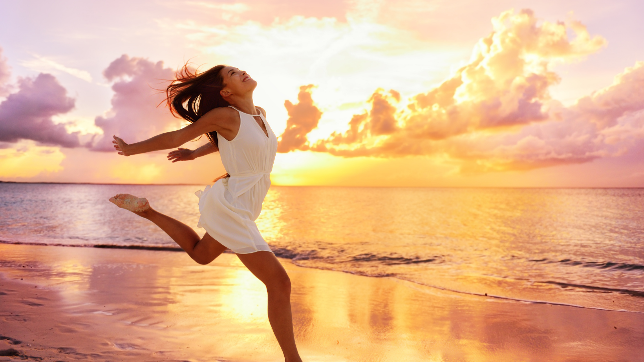 Woman running free on the beach with the sunset - Cut the ego fear based bullshit and let your soul come through - Leanne Juliette