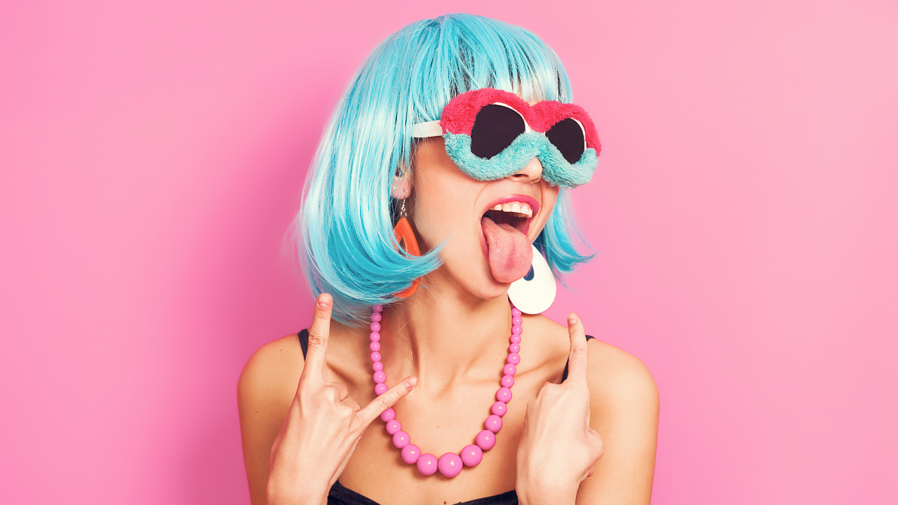 Woman with blue hair, funky glasses and a rebel misfit attitude owning her uniqueness instead of conforming or fitting in