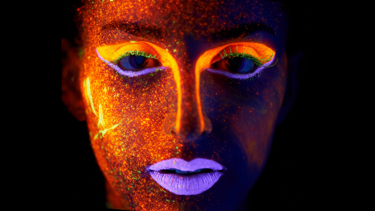 Woman with neon psychedelic face paint - otherworldly - starseed alien and futuristic looking