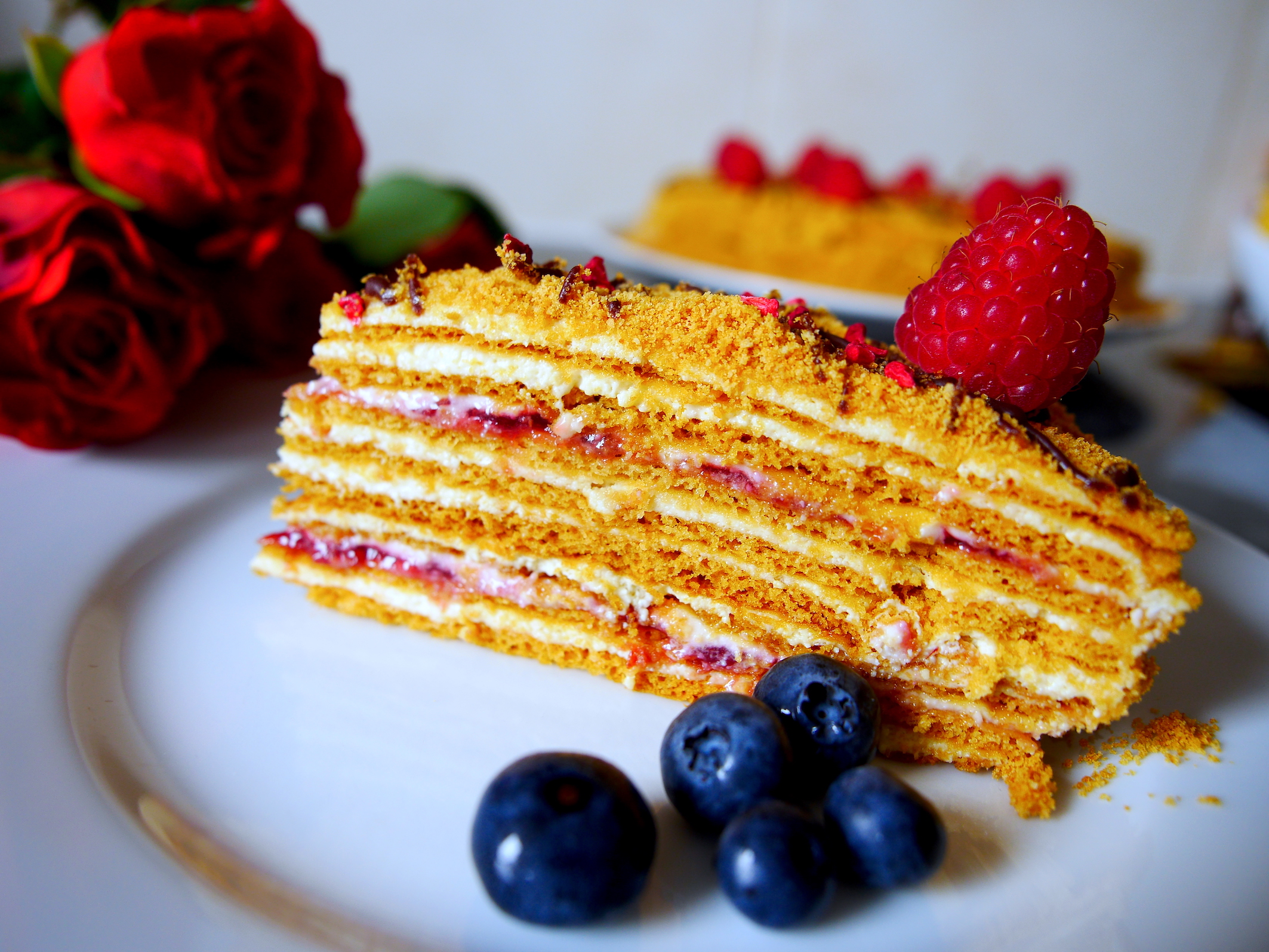 Honey cake with raspberry (Medovik) decorated with fresh raspberries
