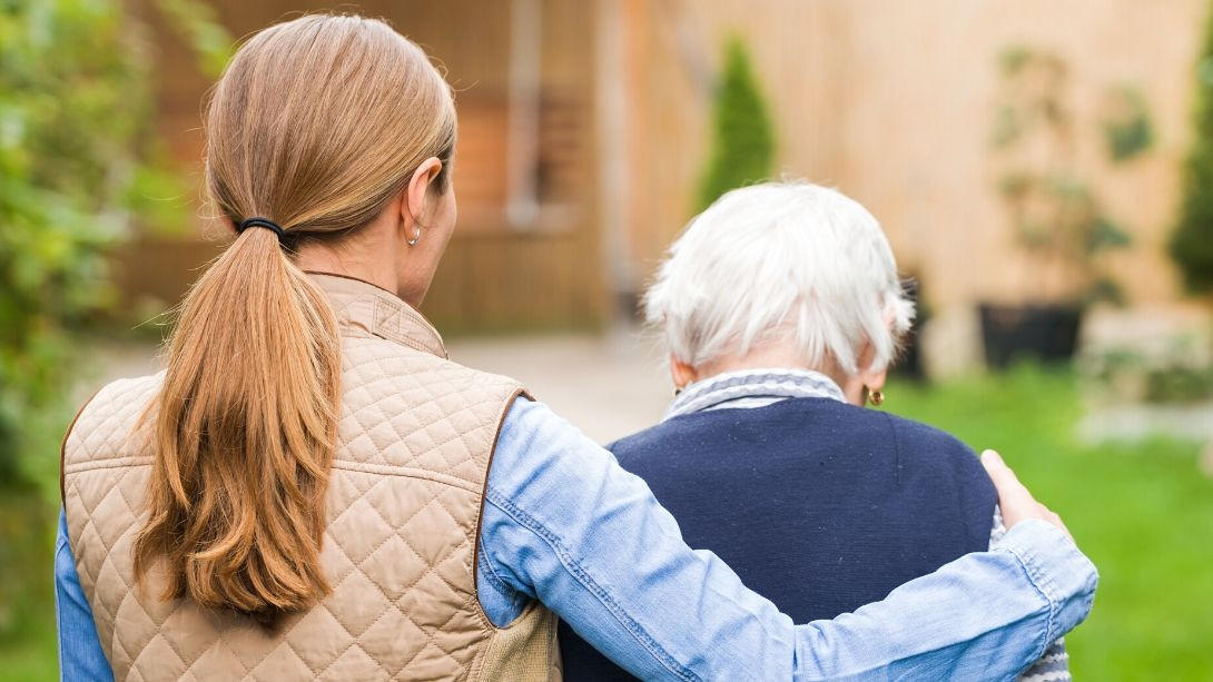 young woman supporting elderly parent