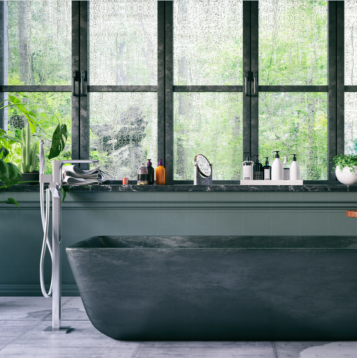 A charcoal granite bath tub with modern faucets.