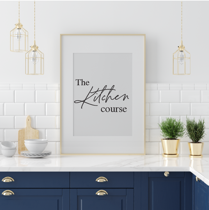 A framed image of the words The Kitchen Course on a kitchen counter.