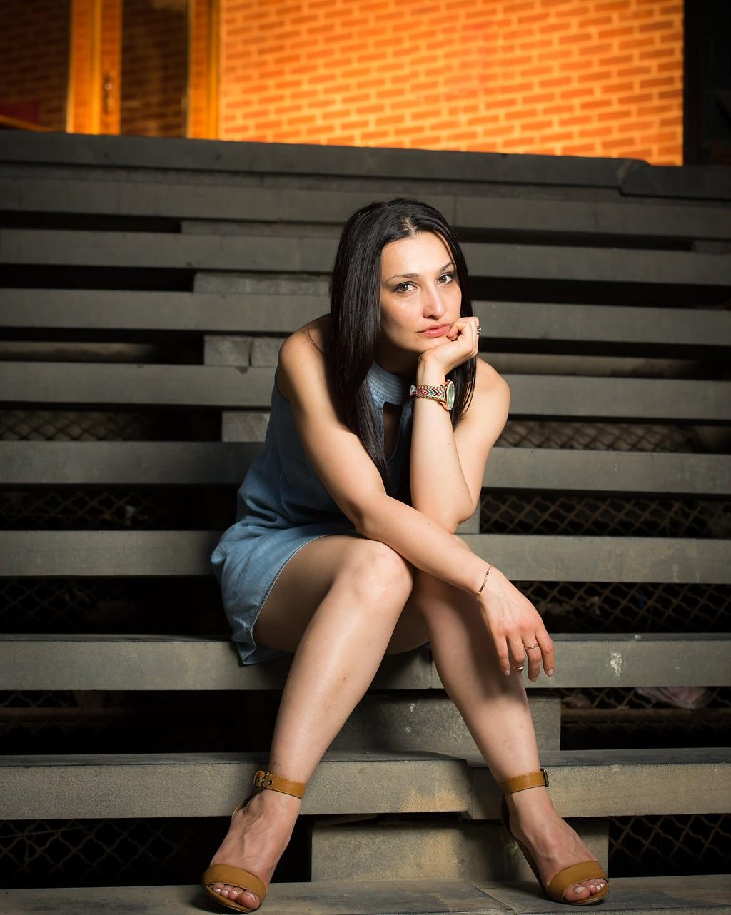 Anahit host of Viva La Flora Live Podcast seating on steps