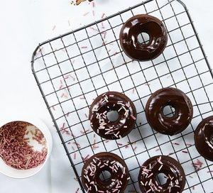 gluten free chocolate donuts on a cooling rack
