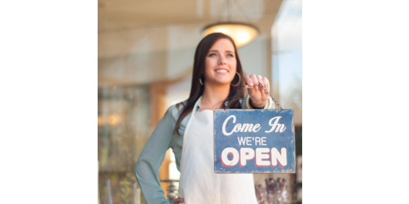 Happy business woman because of the stress free environment brought about by Small Business Training and Coaching.