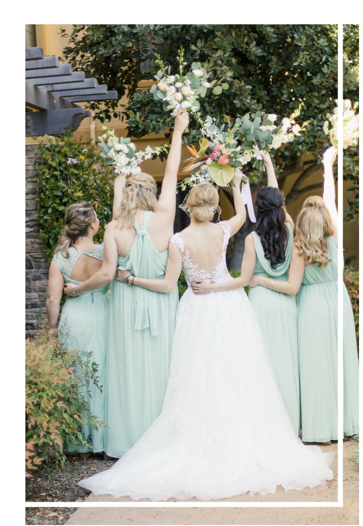 Bride and bridesmaids with sage dresses holding flowers
