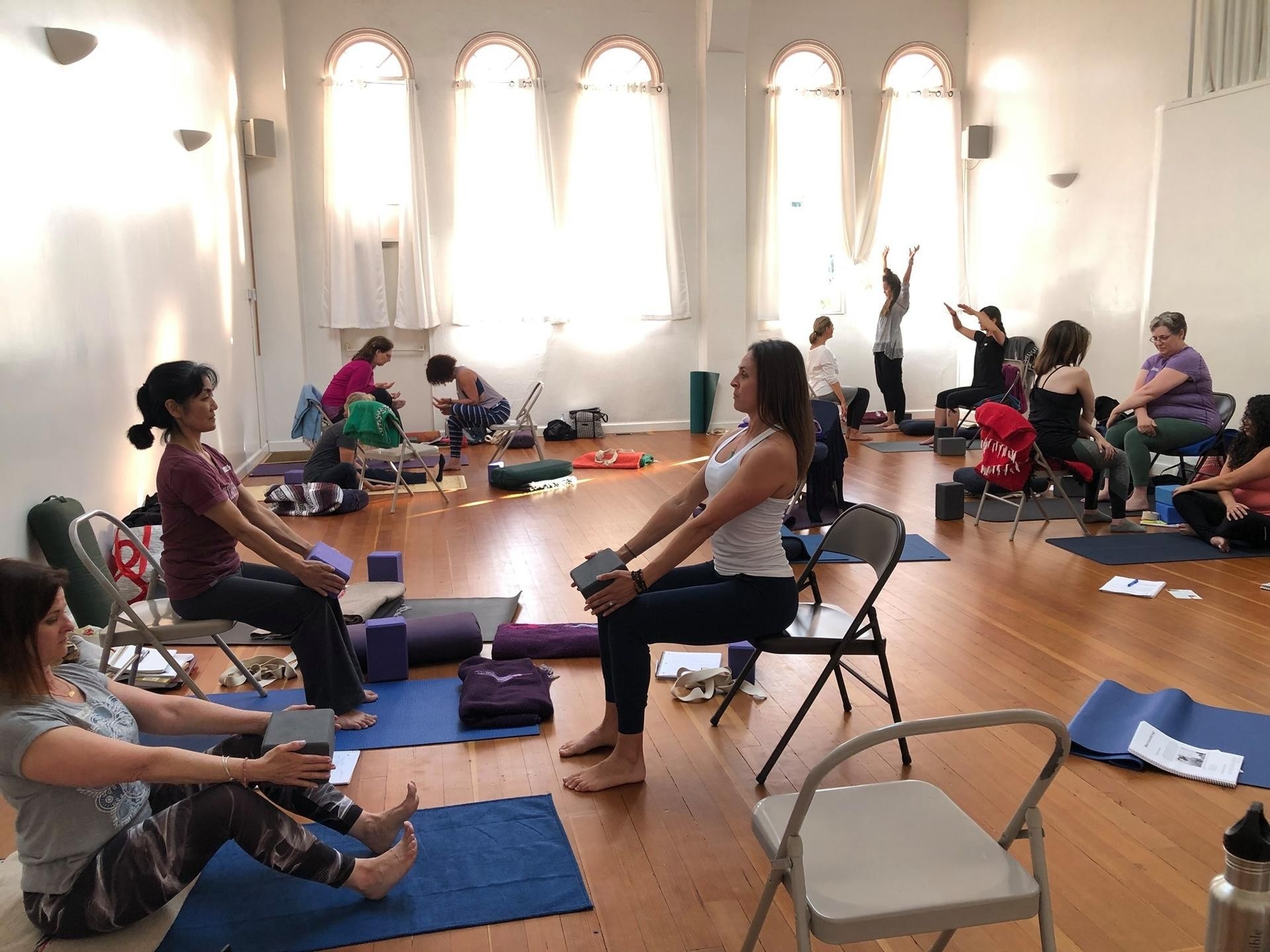 Photograph of yoga teachers practicing together at the Accessible Yoga Training Intensive