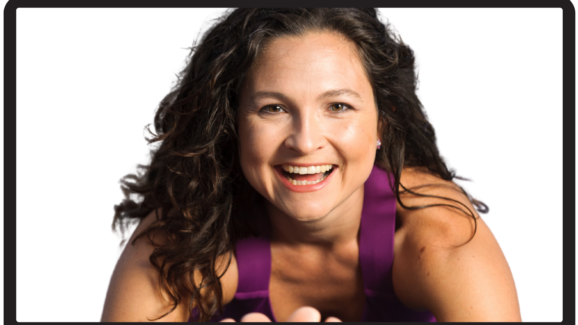 Picture of a woman smiling while doing Pilates