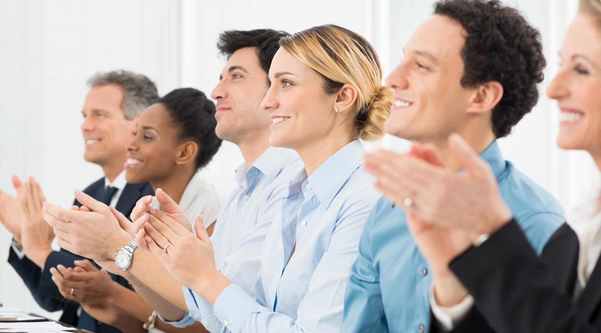 Engaged people clapping their hands