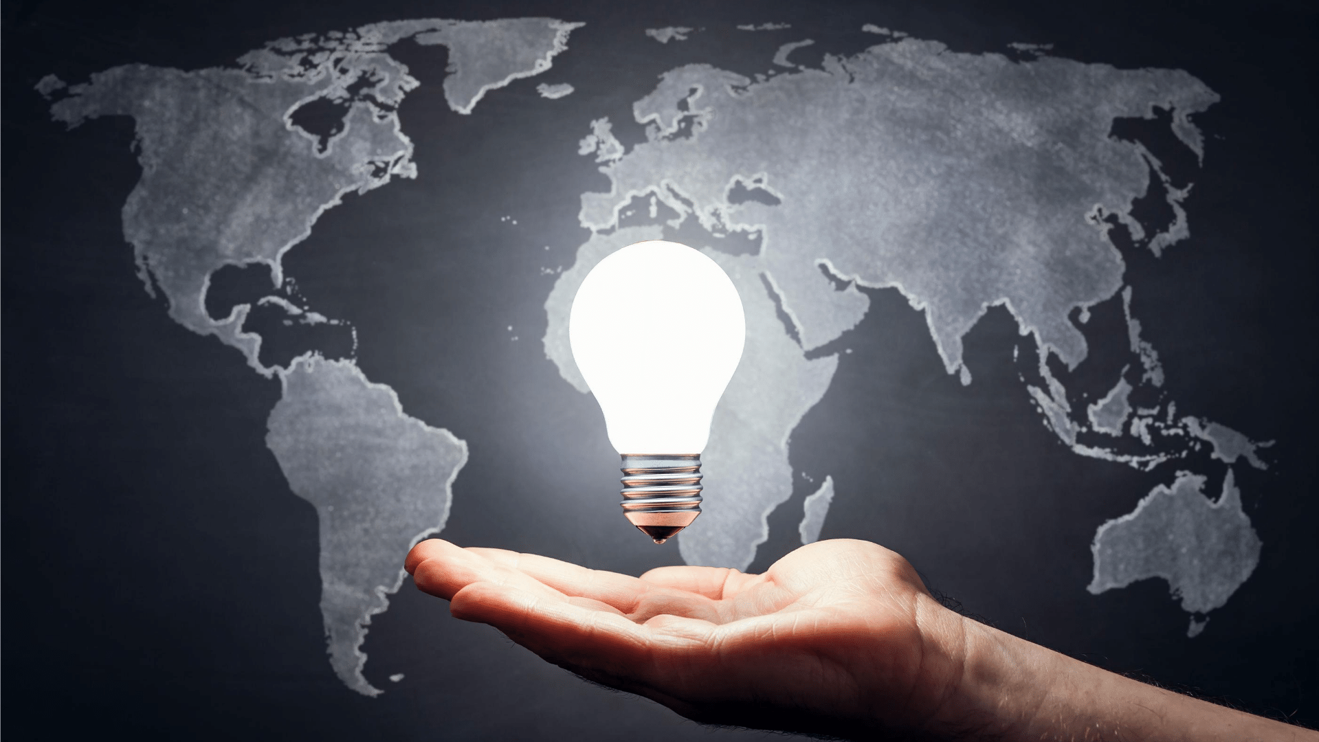 world map lit lightbulb above open palm