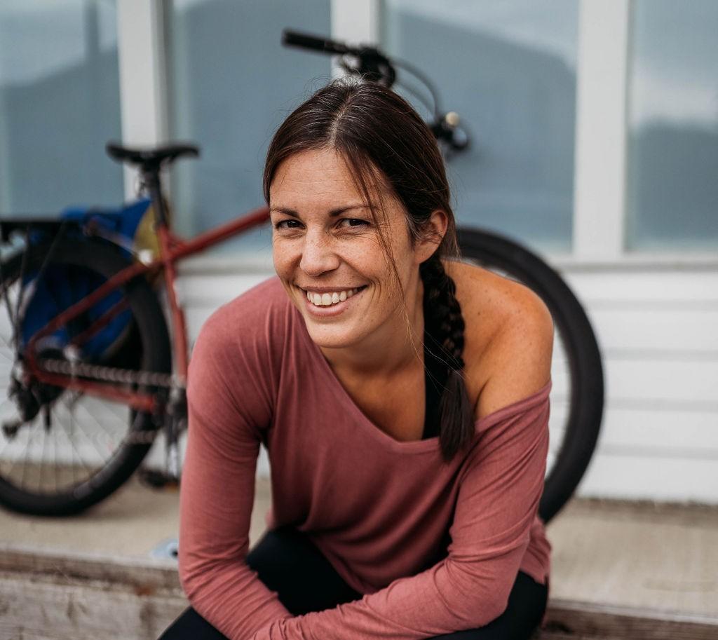 Rebecca Rankin sitting in front of a surly bicycle