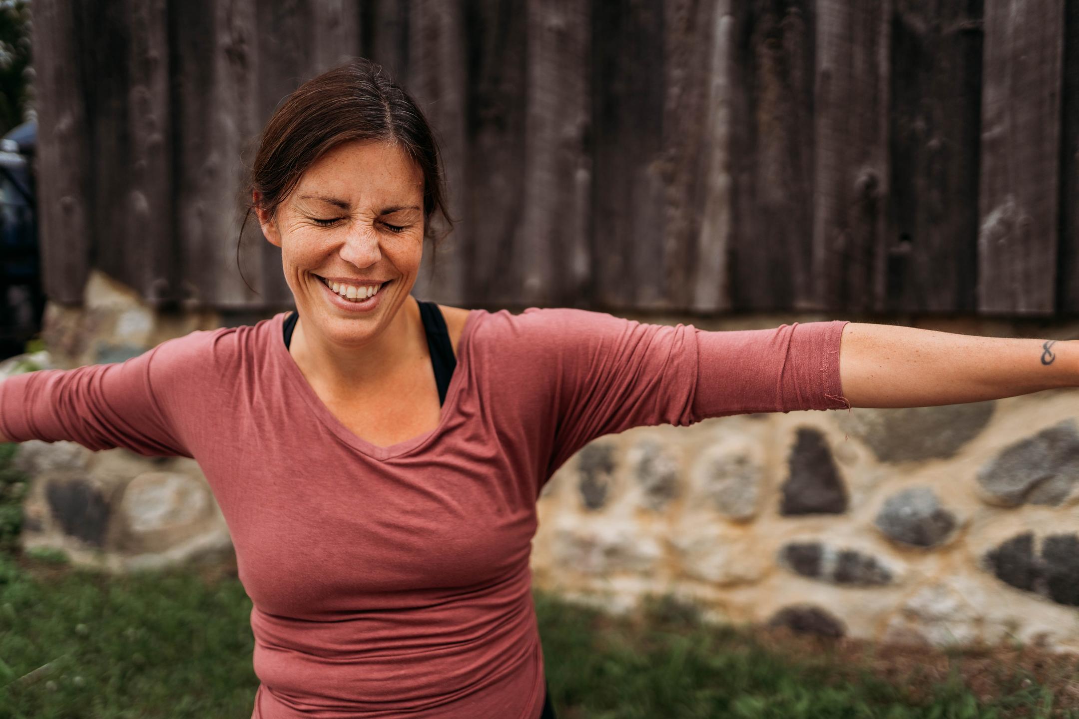 Rankin smiling in warrior II Yoga Pose