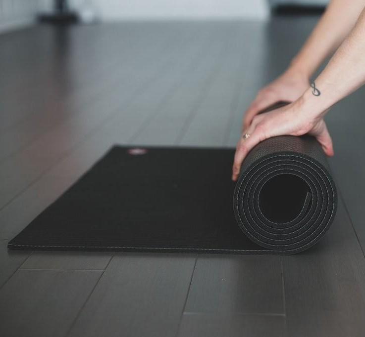 Unrolling of black yoga mat