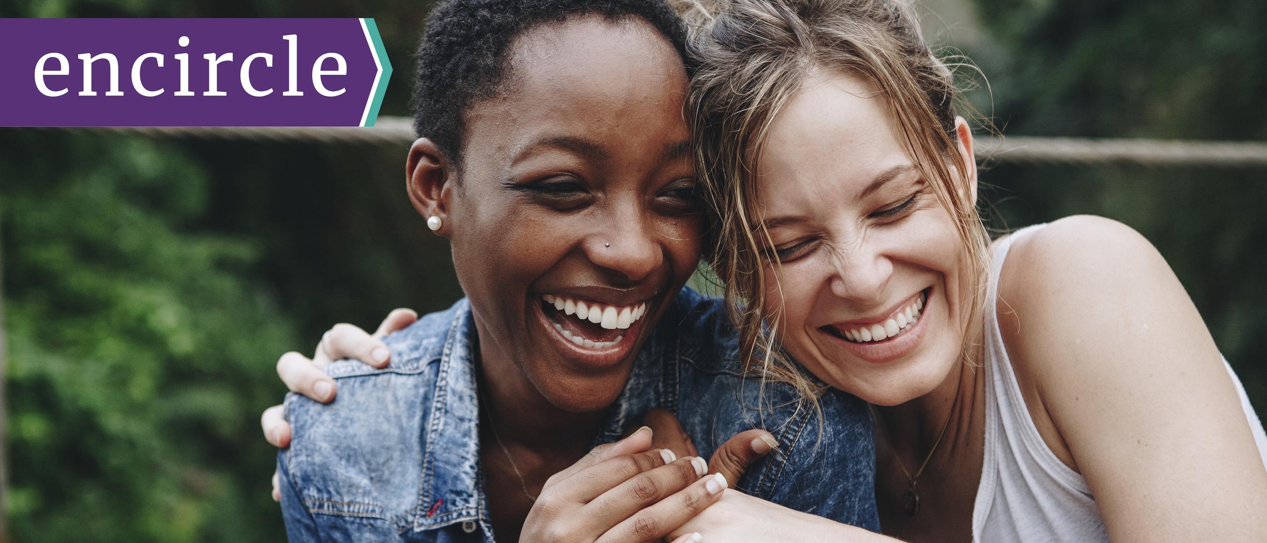 two women smiling with the word encircle