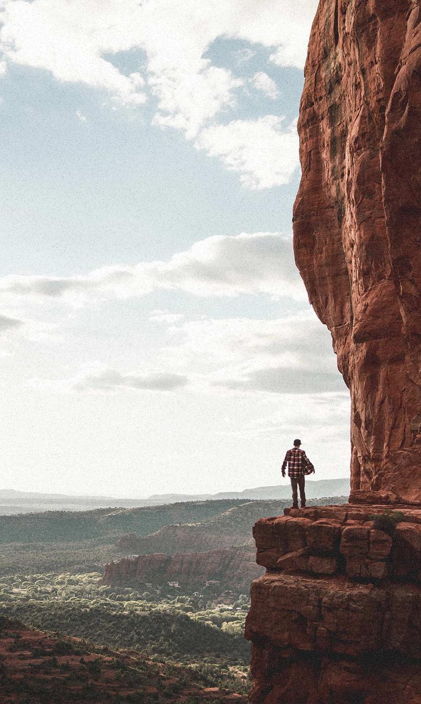 Person up high on a cliff