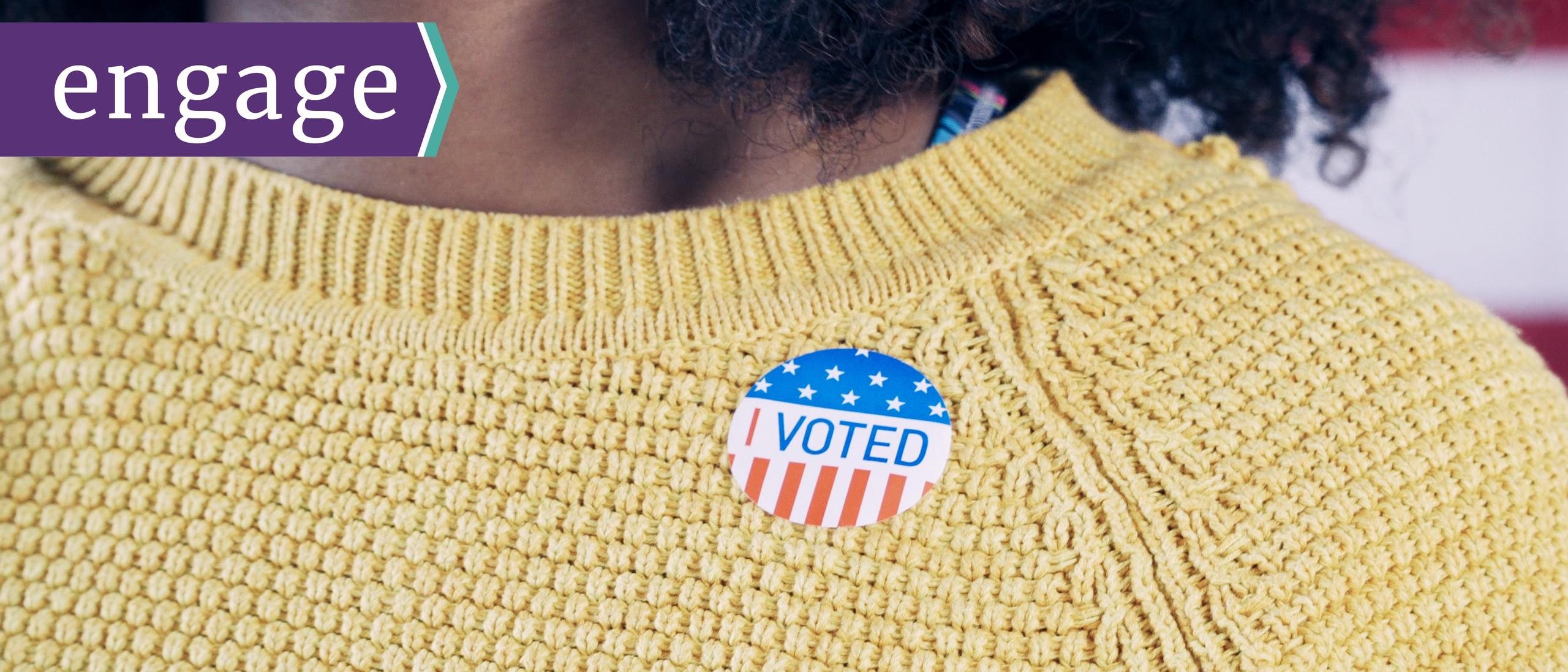 I voted sticker on a woman's sweater