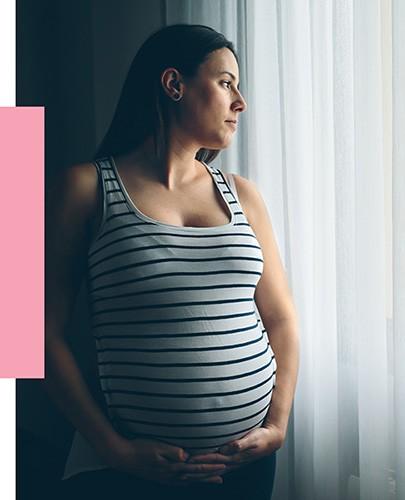 Pregnant Women Gazing Out Window