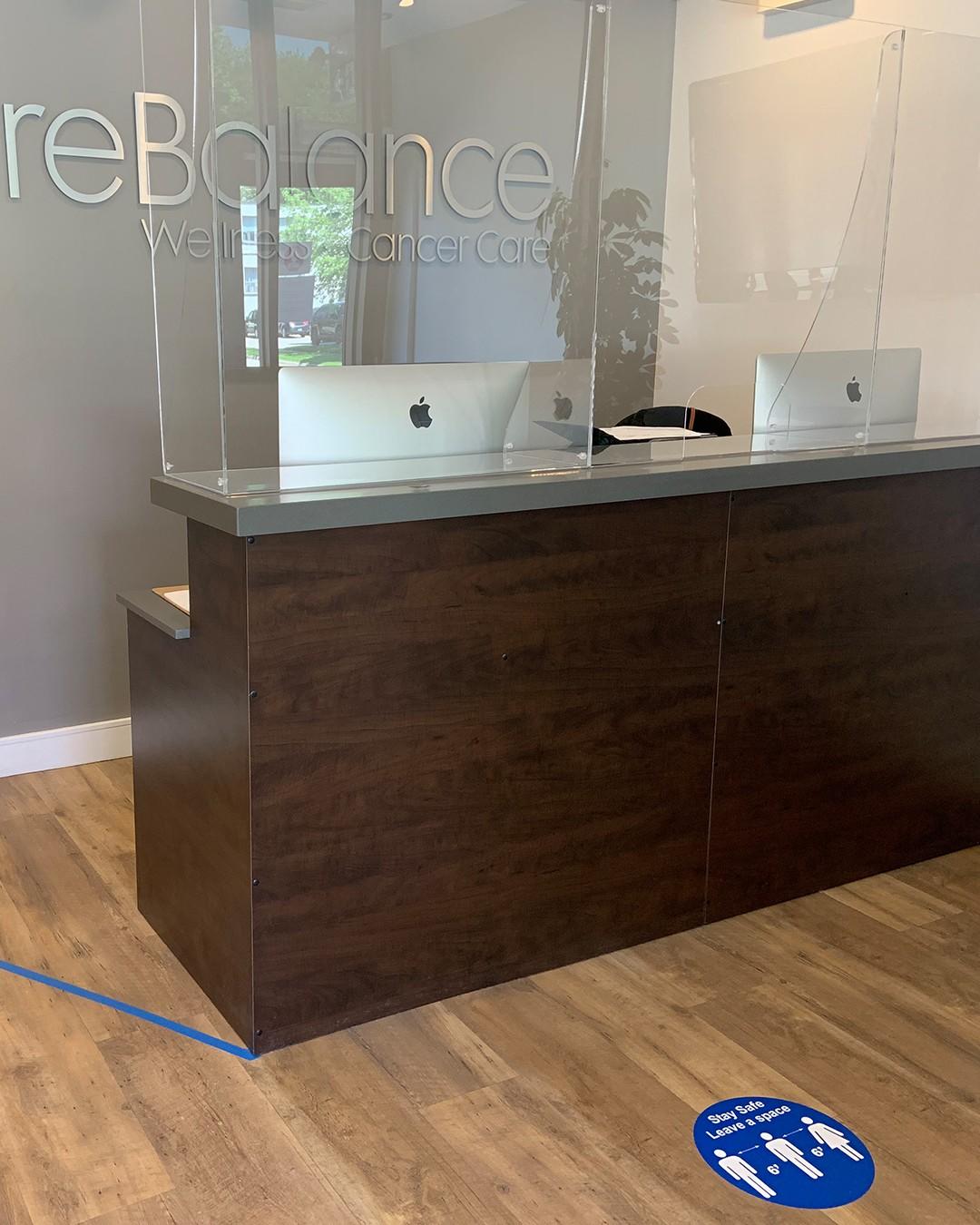 decal on floor in front of desk showing where to stand