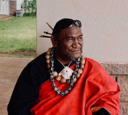 Kumu Paʻa Lawrence Aki in red kīkepa