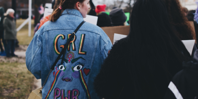 Girl with GRL PWR Jacket