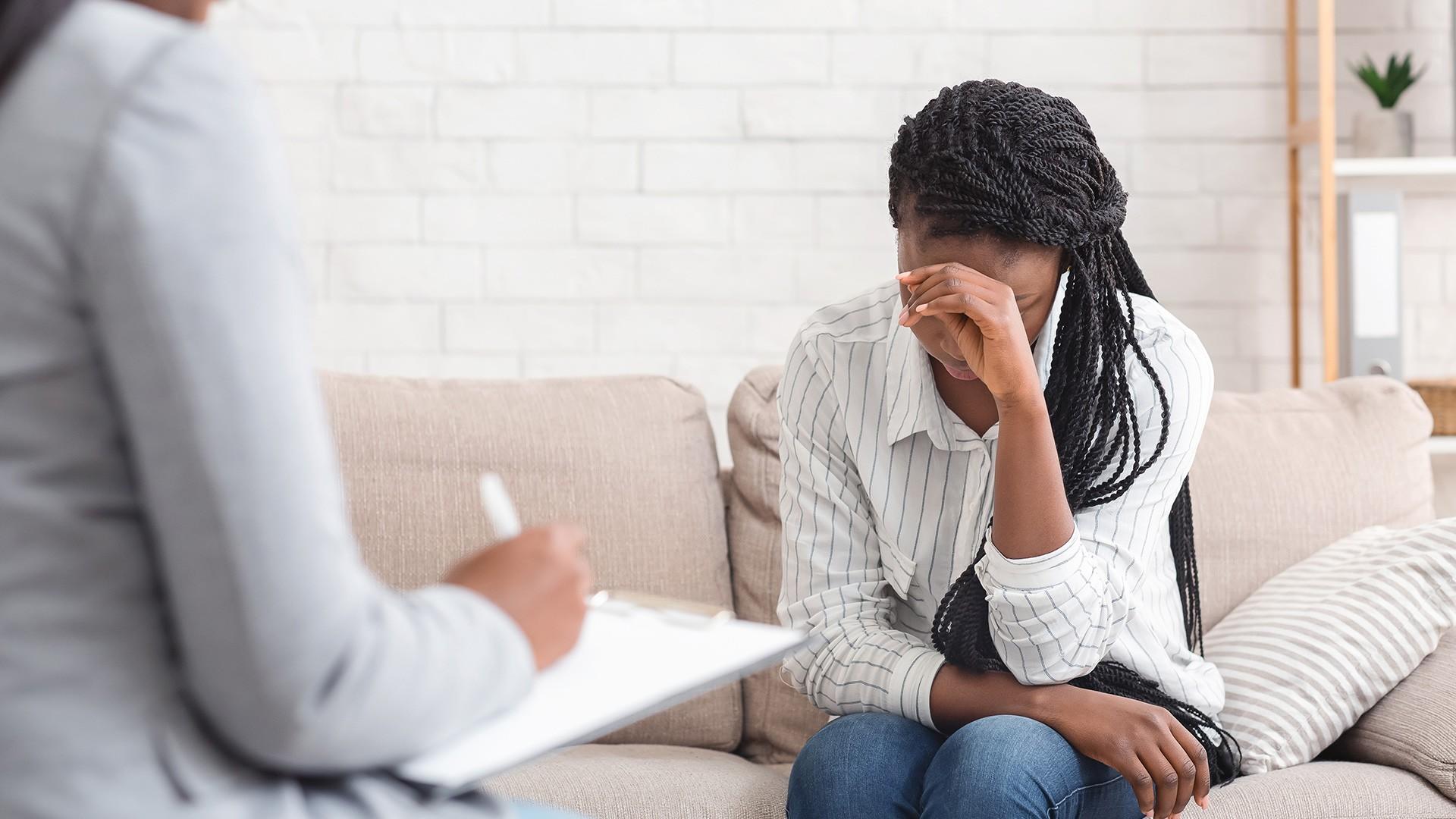 depressed african american female receiving counselling