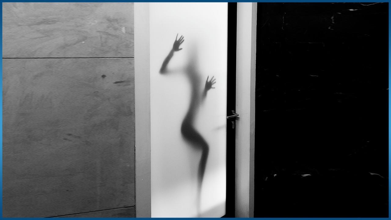 person standing behind opaque window