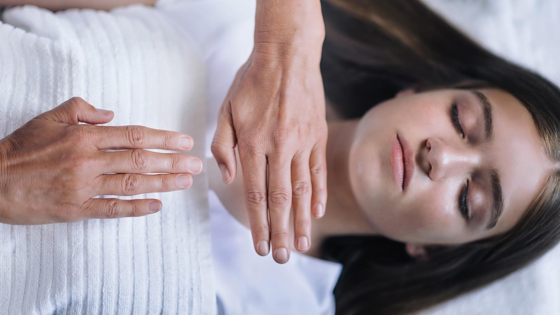 woman receiving energy healing treatment