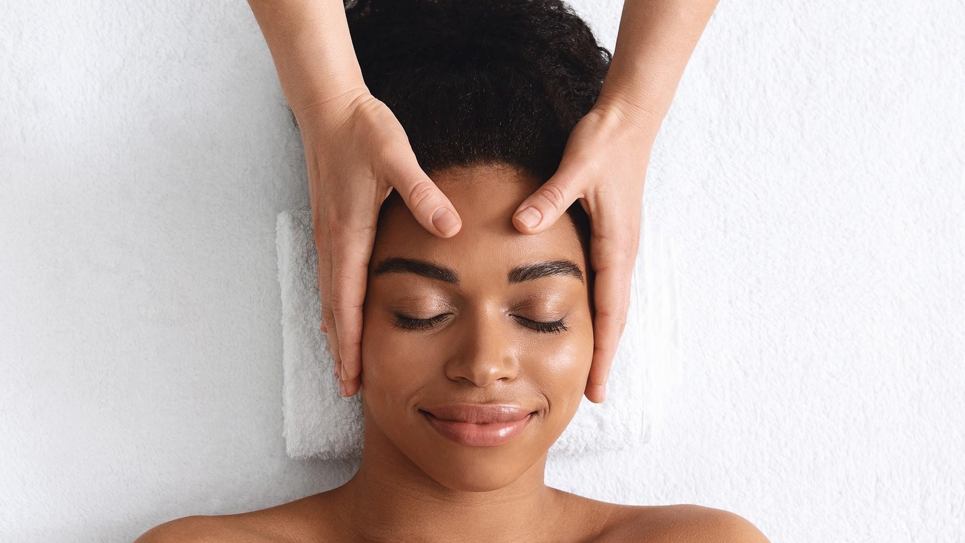 african american woman getting a head massage - Indian Head Massage offered at pureBalance Wellness