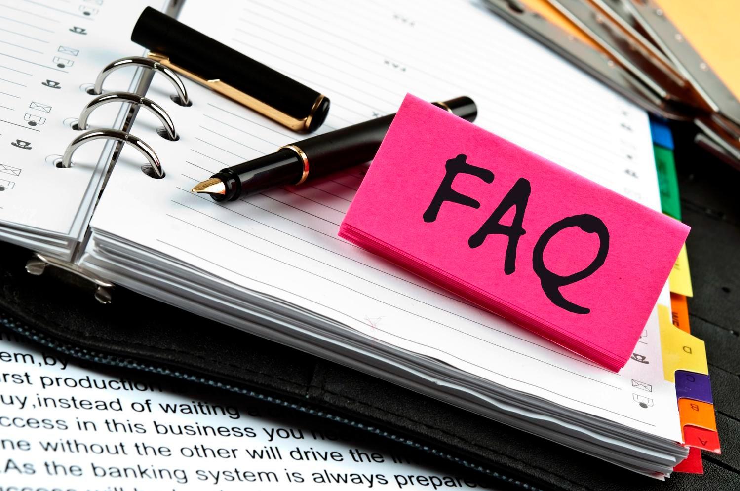 FAQ Sign Sitting on Planner