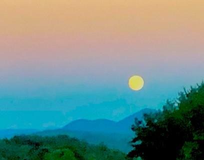 Full moon rising over the mountains, cycles of day and night reflected in the Wise Woman Tradition