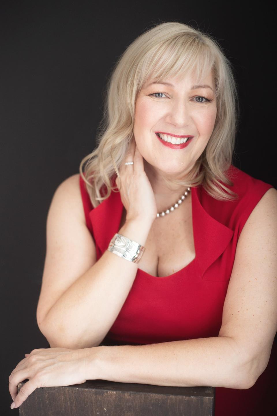 picture of Beth Ann in a red dress, smiling