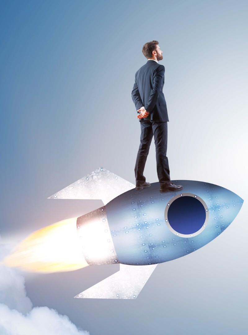 businessman standing on a rocket
