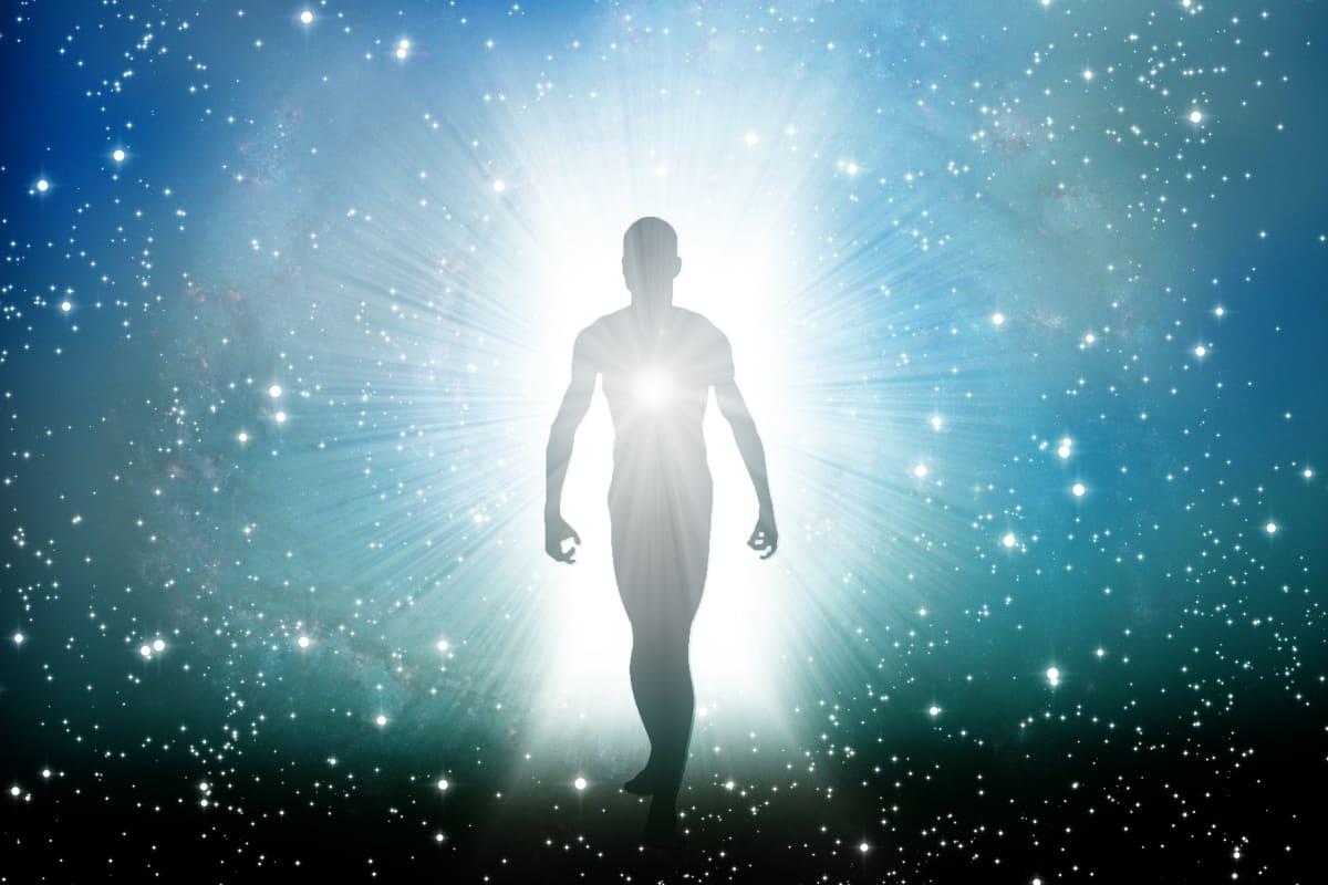 human figure stepping out of a galactic burst of light