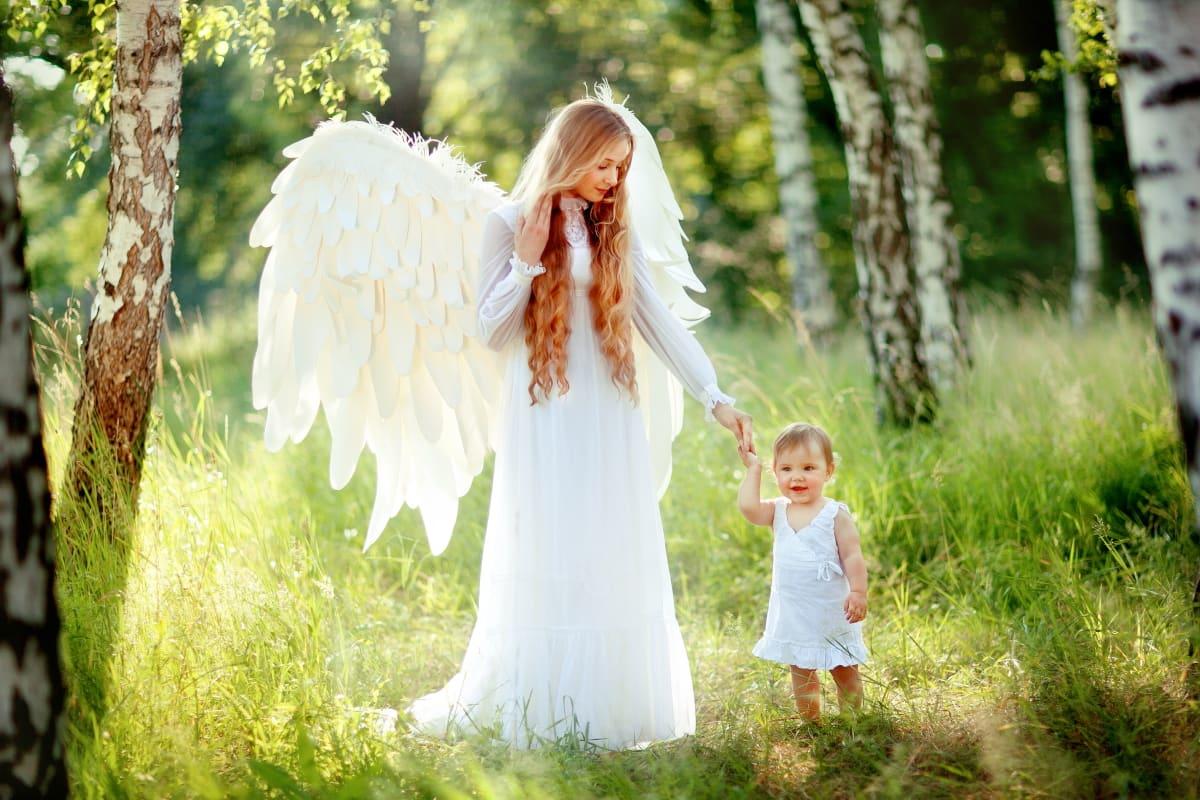 beautiful angel guiding a small child