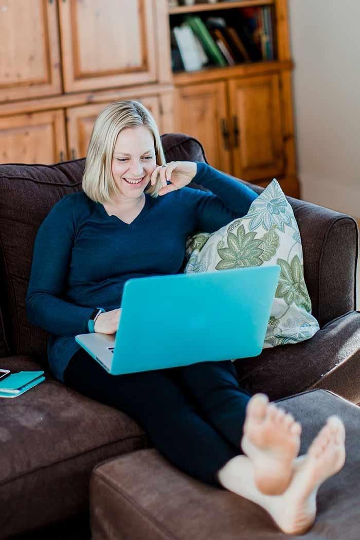 Picture of Stacey Nachajski sitting on couch with teal laptop in her lap