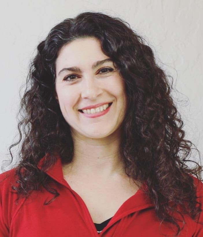curly haired woman in red shirt