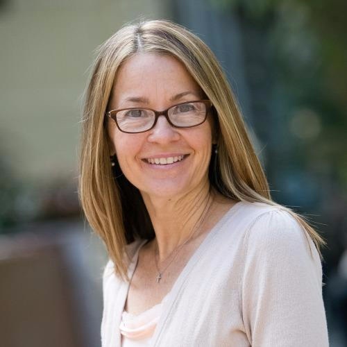 woman with glasses and white shirt