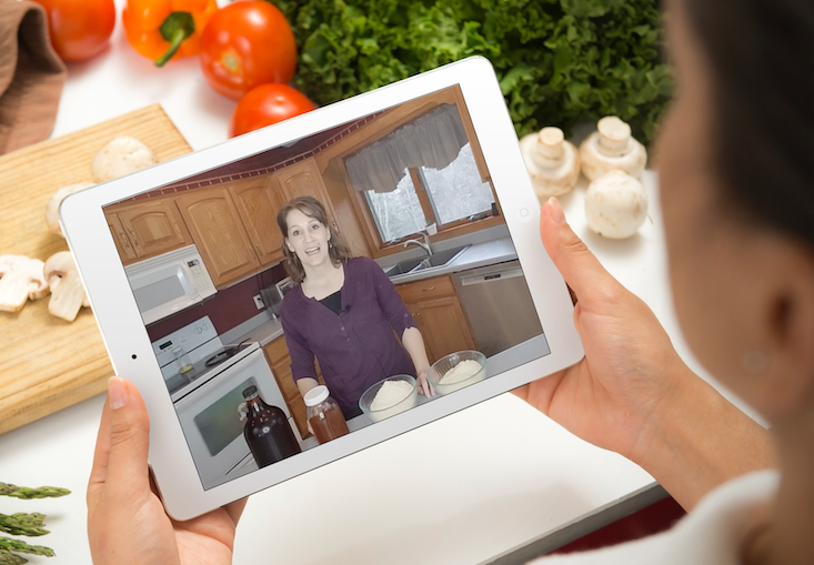woman holding iPad in kitchen