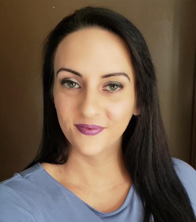 woman with black hair and blue shirt