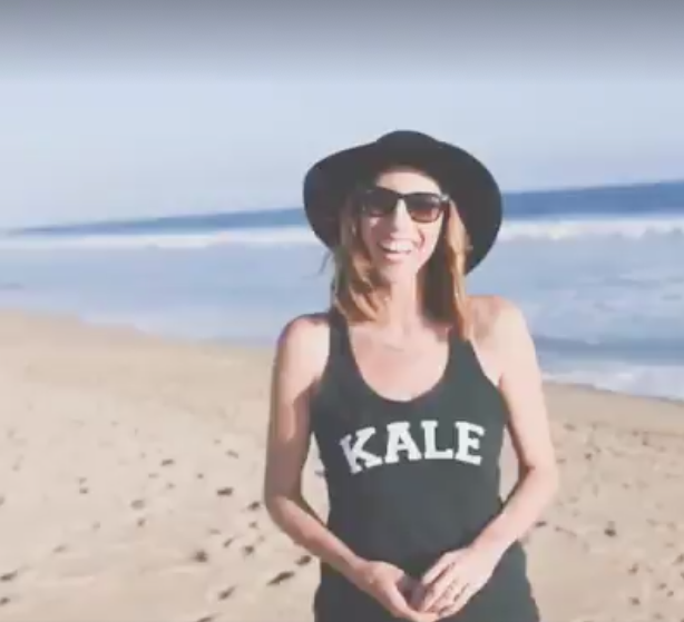woman in floppy hat standing on beach