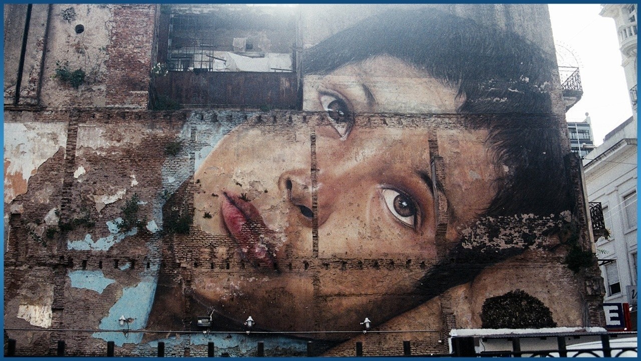 painting of woman on brick wall