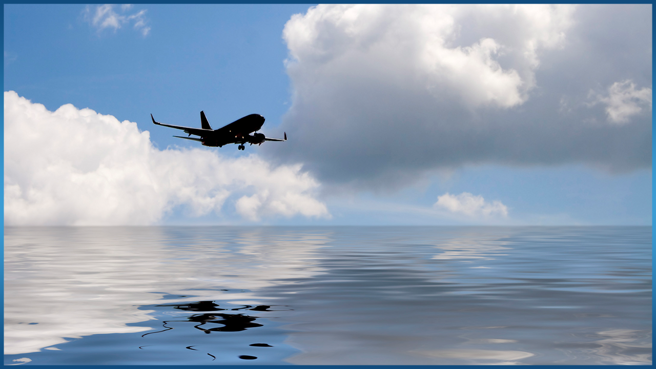 plane flying low over ocean